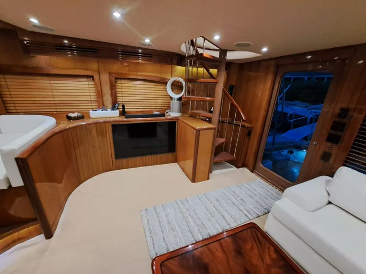 Mary Rose Yacht Photos Pics Luxurious interior of 2006 Hatteras 68 Convertible yacht with wooden finishes and modern amenities.