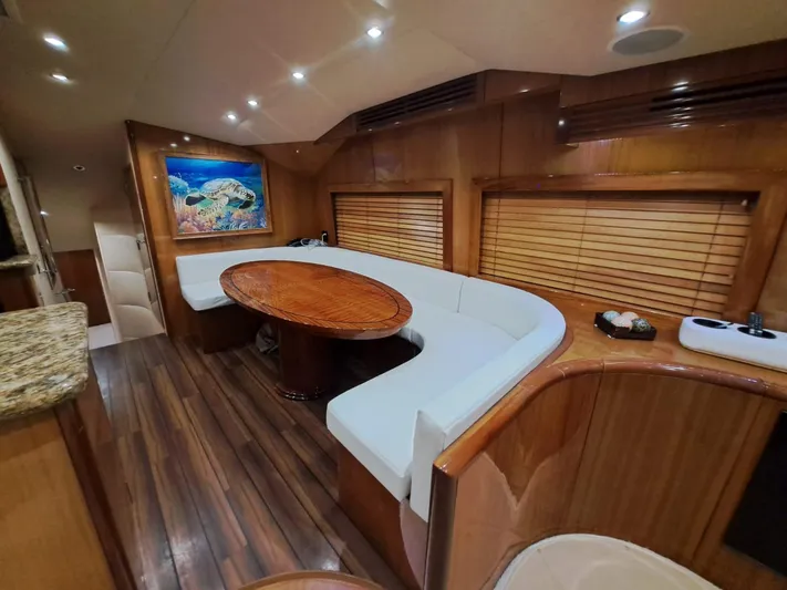 Mary Rose Yacht Photos Pics Luxurious interior of 2006 Hatteras 68 Convertible yacht with elegant wood finishes.