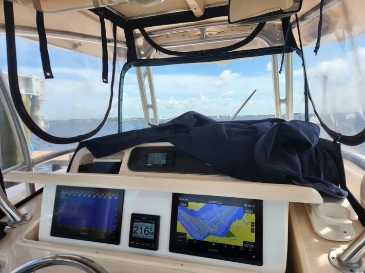  Yacht Photos Pics Grady-White Canyon 336 helm with navigation screens, 2012 model, on a sunny day.
