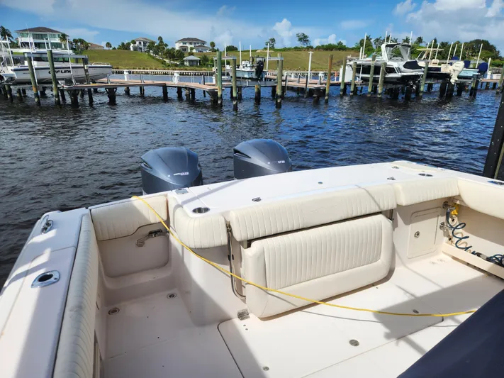  Yacht Photos Pics 2012 Grady-White Canyon 336 boat docked, featuring spacious seating and dual outboard engines.