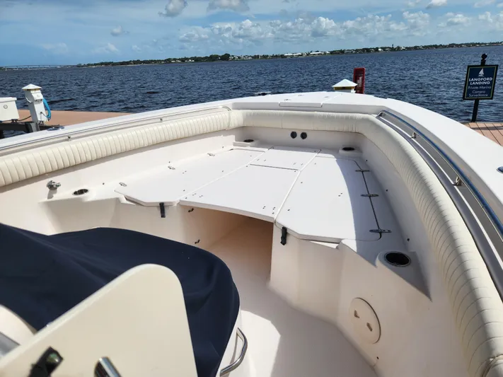 Yacht Photos Pics 2012 Grady-White Canyon 336 boat interior, docked by the water under a partly cloudy sky.