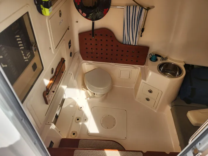  Yacht Photos Pics 2012 Grady-White Canyon 336 boat interior with toilet, sink, and storage.