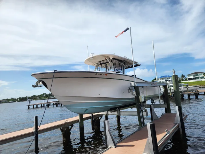  Yacht Photos Pics 2012 Grady-White Canyon 336 boat docked on a lift by the water.
