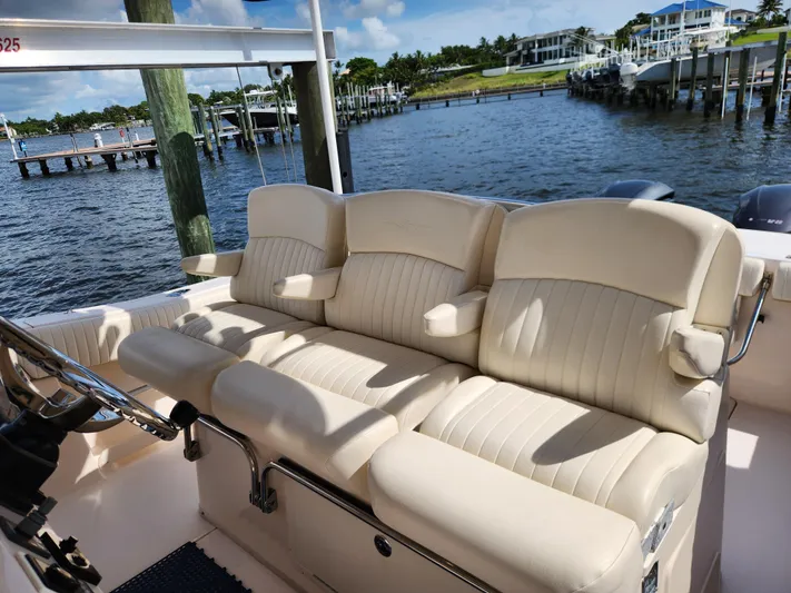  Yacht Photos Pics Luxurious seating on 2012 Grady-White Canyon 336 boat, docked by scenic waterfront.