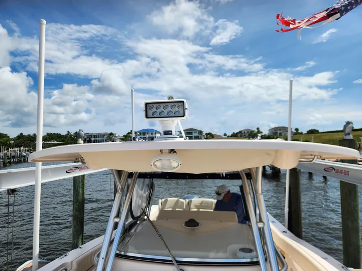  Yacht Photos Pics 2012 Grady-White Canyon 336 boat docked under a blue sky with American flag.