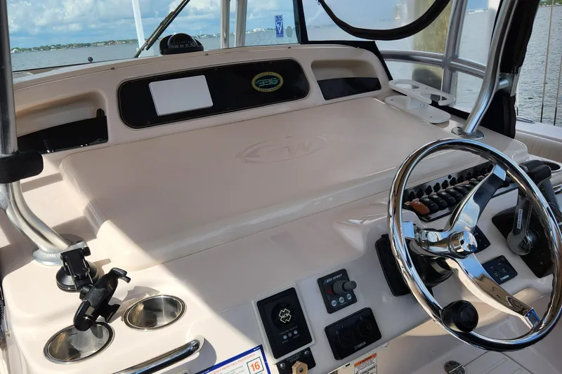  Yacht Photos Pics 2012 Grady-White Canyon 336 helm with steering wheel and control panel, overlooking water.