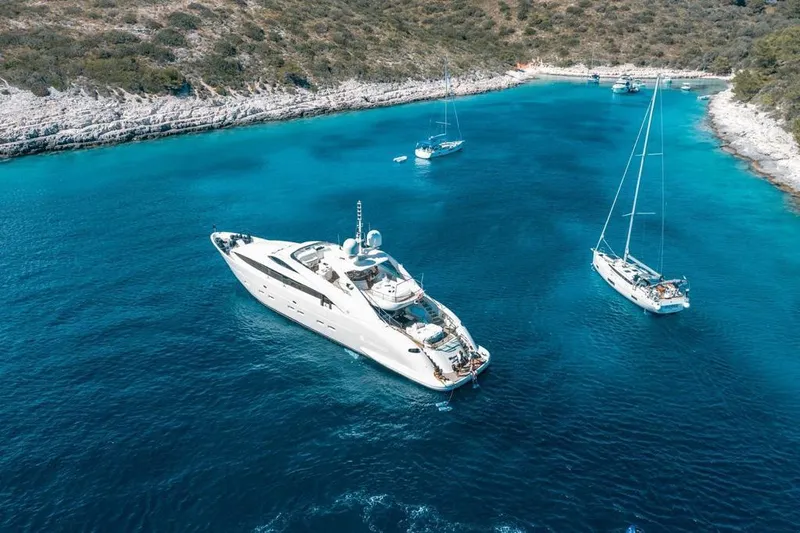  Yacht Photos Pics Luxurious 2008 ISA 120 Sport yacht anchored in a serene, turquoise bay.