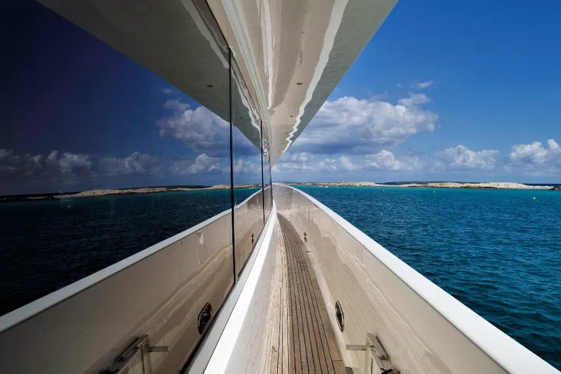  Yacht Photos Pics Sleek ISA 120 Sport yacht reflecting ocean view, 2008 model, cruising in clear blue waters.