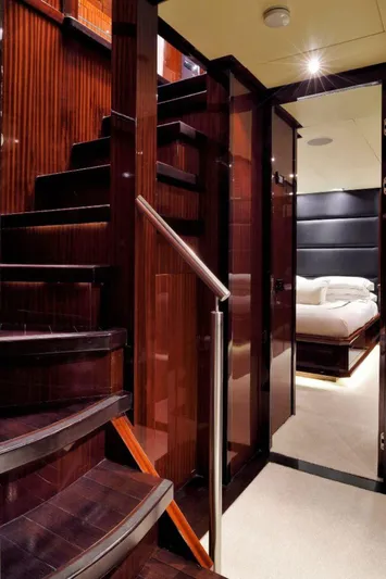  Yacht Photos Pics Luxurious interior of 2008 ISA 120 Sport yacht with elegant wooden staircase.