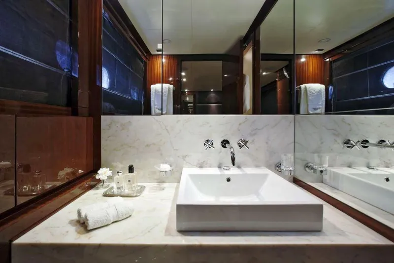  Yacht Photos Pics Luxurious yacht bathroom with marble sink, elegant fixtures, and mirrored walls in a 2008 ISA 120 Sport.