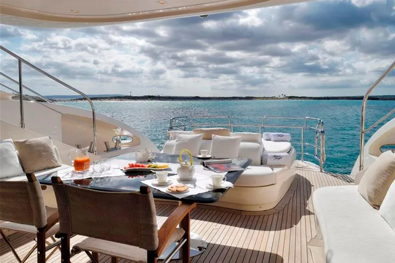  Yacht Photos Pics Luxury yacht deck with dining setup, ocean view; ISA 120 Sport, 2008 model.