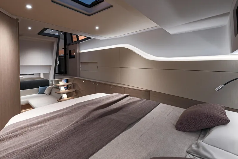 On Order Yacht Photos Pics Luxurious interior of 2026 Beneteau Gran Turismo 40 yacht, featuring modern design and cozy bedding.