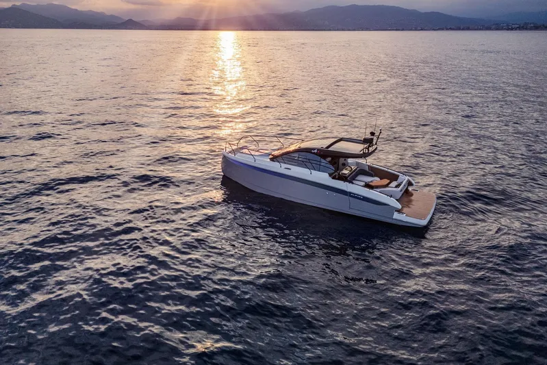 On Order Yacht Photos Pics 2026 Beneteau Gran Turismo 40 yacht on serene water at sunset.