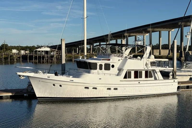  Yacht Photos Pics Luxury 2003 Selene 53 yacht docked by a bridge on a sunny day.