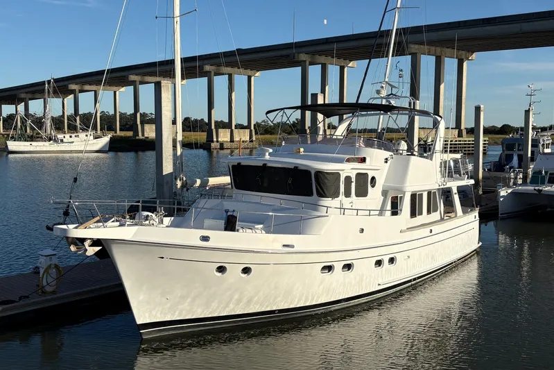  Yacht Photos Pics Luxury 2003 Selene 53 yacht docked near a bridge on a sunny day.