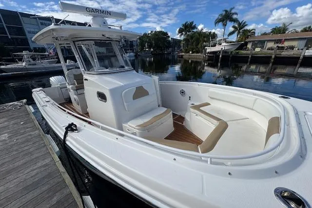  Yacht Photos Pics 2022 Edgewater 280CC boat docked, featuring spacious seating and modern design.