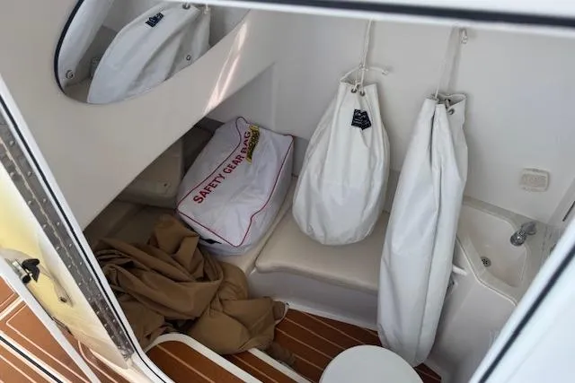  Yacht Photos Pics 2022 Edgewater 280CC interior with safety gear bag and storage area.