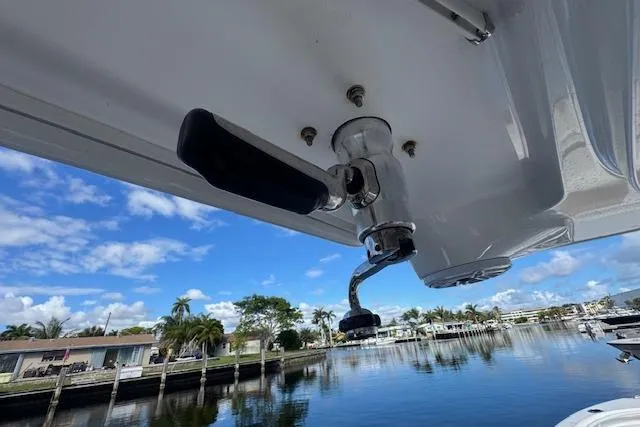  Yacht Photos Pics 2022 Edgewater 280CC boat detail with fishing rod holder, scenic waterfront view.