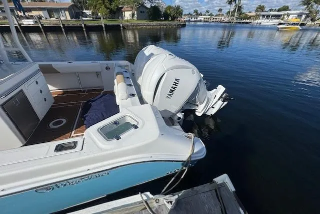  Yacht Photos Pics 2022 Edgewater 280CC boat docked, featuring Yamaha outboard engines, calm water background.