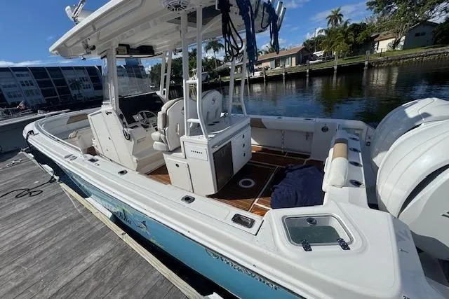  Yacht Photos Pics 2022 Edgewater 280CC boat docked, featuring spacious deck and modern design.