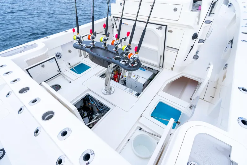  Yacht Photos Pics 2024 SeaVee 450z fishing boat deck with rod holders and storage compartments.