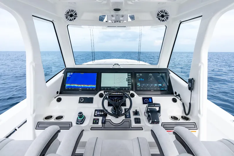  Yacht Photos Pics 2024 SeaVee 450z helm with advanced navigation systems and ocean view.