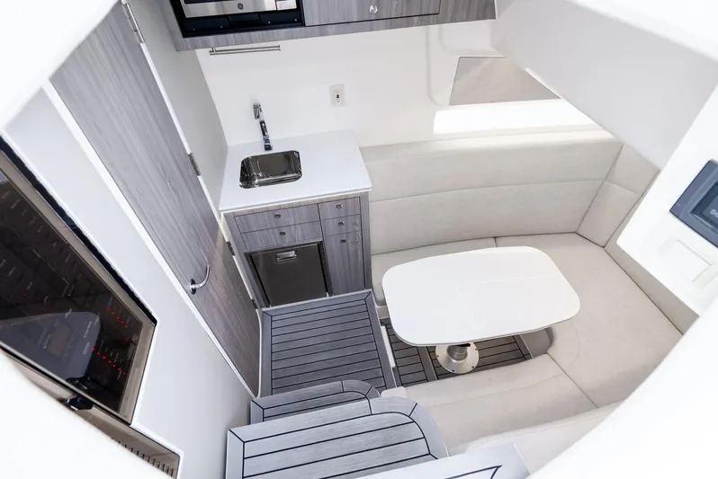  Yacht Photos Pics 2024 SeaVee 450z interior with modern kitchenette and seating area.