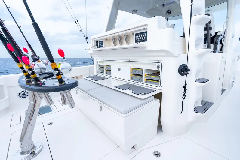  Yacht Photos Pics 2024 SeaVee 450z fishing boat deck with rods and storage compartments.