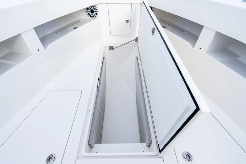  Yacht Photos Pics 2024 SeaVee 450z boat storage compartment with open hatch, showcasing spacious interior.