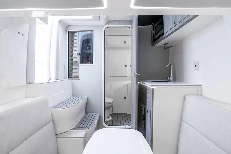  Yacht Photos Pics 2024 SeaVee 450z interior with modern kitchenette and compact bathroom.