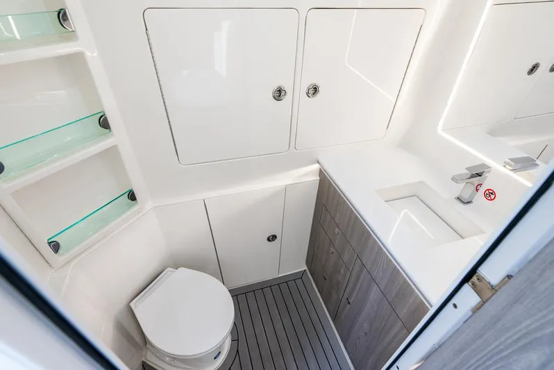  Yacht Photos Pics 2024 SeaVee 450z boat bathroom with modern fixtures and storage cabinets.