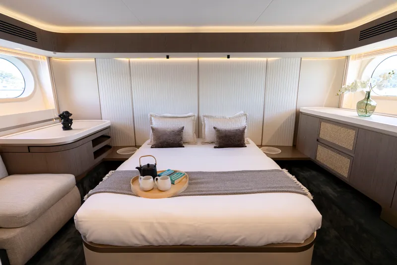 Olivia Yacht Photos Pics Luxurious bedroom interior of 2025 Azimut Magellano 60 yacht with elegant decor and natural lighting.