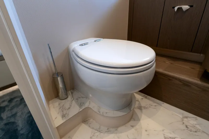Olivia Yacht Photos Pics Luxury bathroom on 2025 Azimut Magellano 60 yacht with modern toilet and marble flooring.