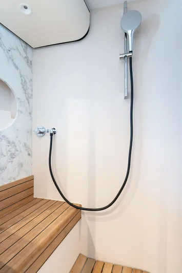 Olivia Yacht Photos Pics Luxury shower area in 2025 Azimut Magellano 60 yacht with wooden seating.