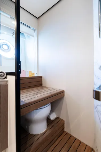 Olivia Yacht Photos Pics Bathroom interior of 2025 Azimut Magellano 60 yacht, featuring modern design and wooden accents.
