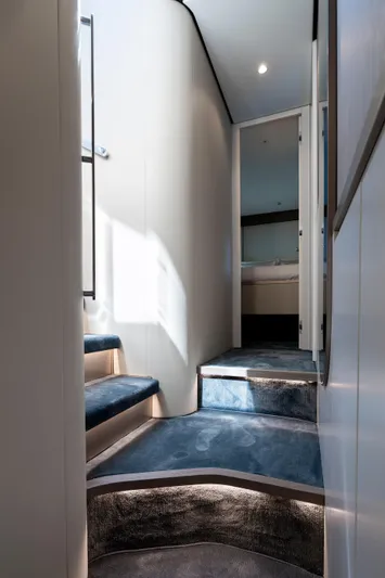 Olivia Yacht Photos Pics Interior staircase of 2025 Azimut Magellano 60 yacht, featuring modern design and soft lighting.