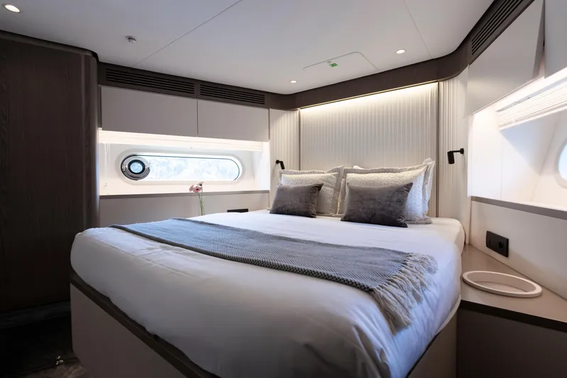 Olivia Yacht Photos Pics Luxurious bedroom interior of 2025 Azimut Magellano 60 yacht, featuring elegant bedding and modern design.