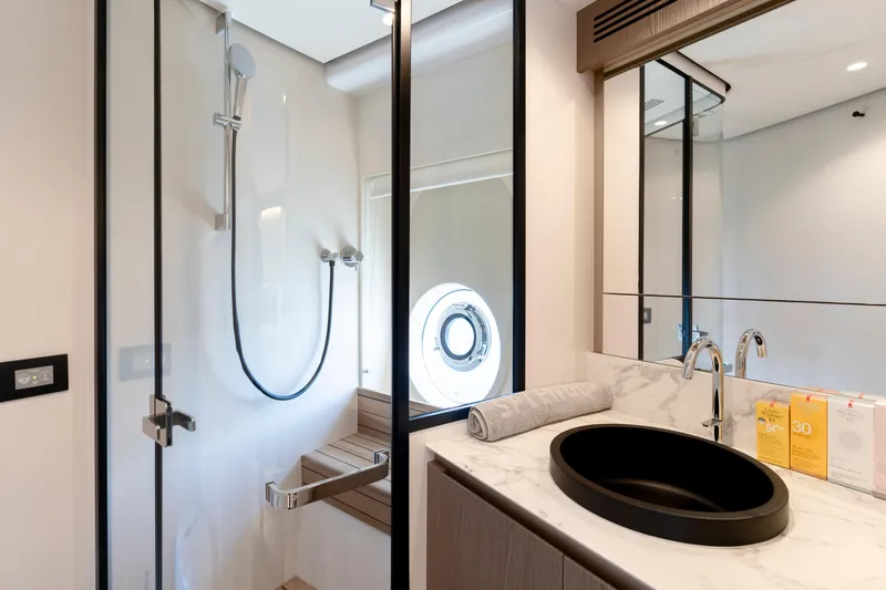 Olivia Yacht Photos Pics Luxurious bathroom in 2025 Azimut Magellano 60 yacht with modern fixtures and elegant design.