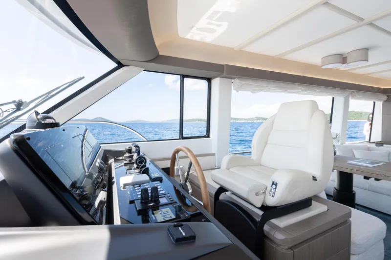 Olivia Yacht Photos Pics Luxurious interior of 2025 Azimut Magellano 60 yacht with modern helm and plush seating.