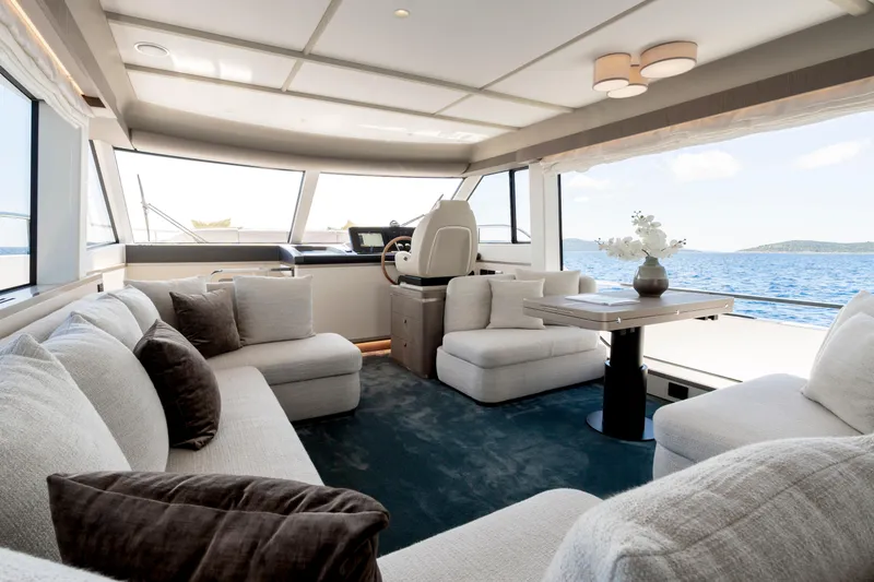 Olivia Yacht Photos Pics Luxurious interior of 2025 Azimut Magellano 60 yacht with elegant seating and ocean view.
