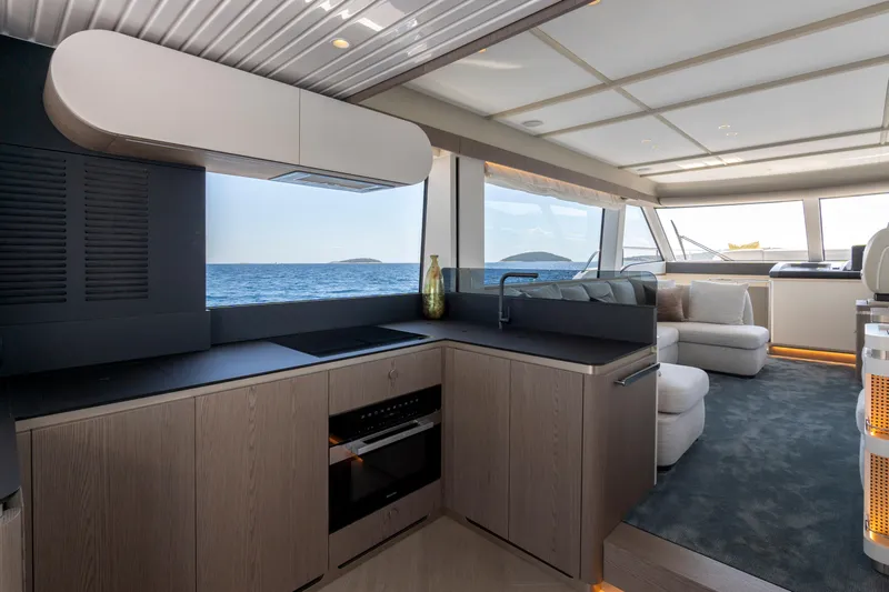 Olivia Yacht Photos Pics Luxurious interior of 2025 Azimut Magellano 60 yacht with modern kitchen and ocean view.
