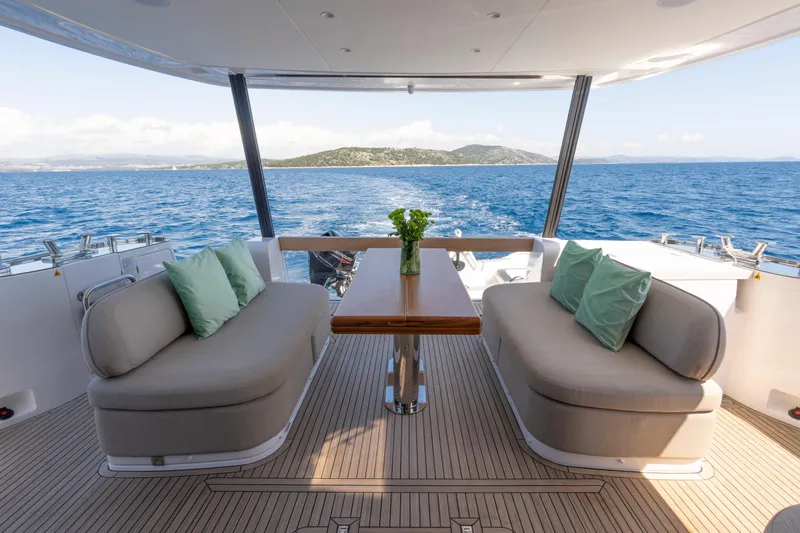 Olivia Yacht Photos Pics Luxurious 2025 Azimut Magellano 60 yacht deck with elegant seating and ocean view.