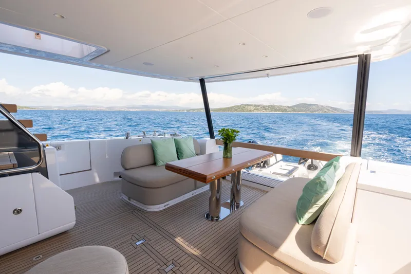 Olivia Yacht Photos Pics Luxurious Azimut Magellano 60 yacht interior, featuring elegant seating and ocean views, 2025 model.