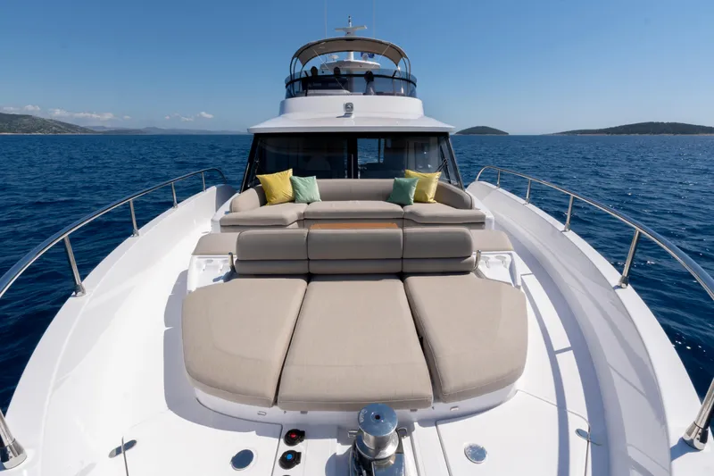 Olivia Yacht Photos Pics 2025 Azimut Magellano 60 yacht with sunbathing area on open sea.