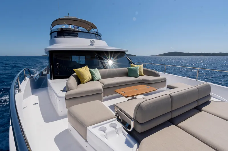 Olivia Yacht Photos Pics Luxurious 2025 Azimut Magellano 60 yacht with spacious deck and elegant seating on open sea.