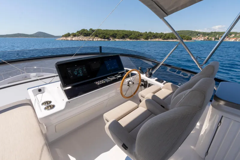 Olivia Yacht Photos Pics 2025 Azimut Magellano 60 yacht helm with dual seats and ocean view.
