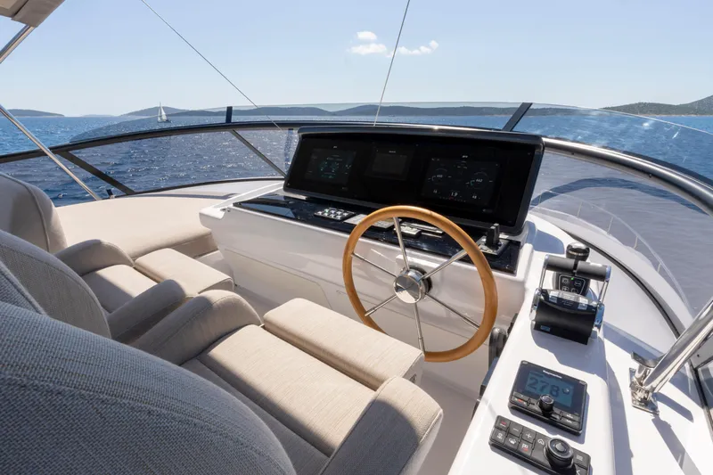 Olivia Yacht Photos Pics Helm of 2025 Azimut Magellano 60 yacht with modern controls and ocean view.