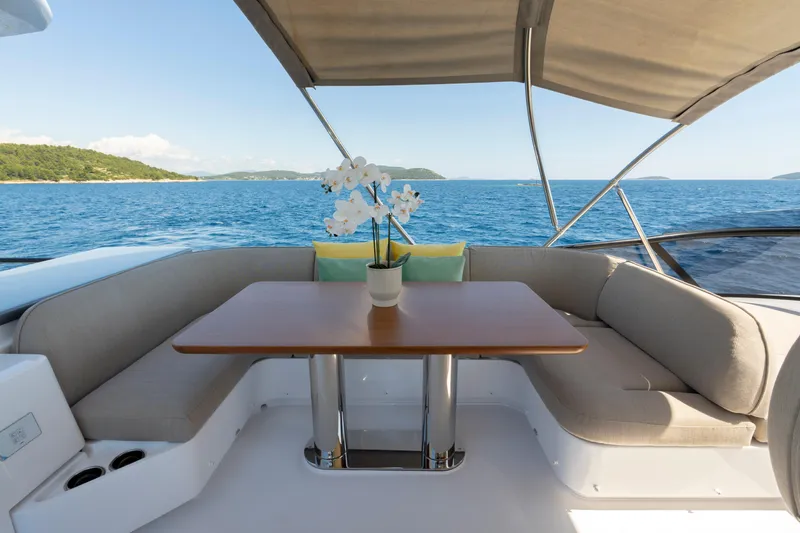 Olivia Yacht Photos Pics Luxurious seating area on 2025 Azimut Magellano 60 yacht with ocean view.