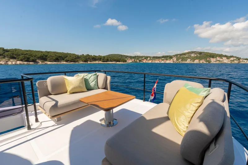 Olivia Yacht Photos Pics Luxurious deck of 2025 Azimut Magellano 60 yacht with scenic ocean view.