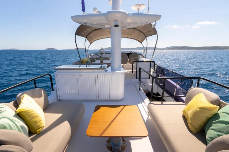 Olivia Yacht Photos Pics Luxurious 2025 Azimut Magellano 60 yacht deck with seating, ocean view, and sunny weather.